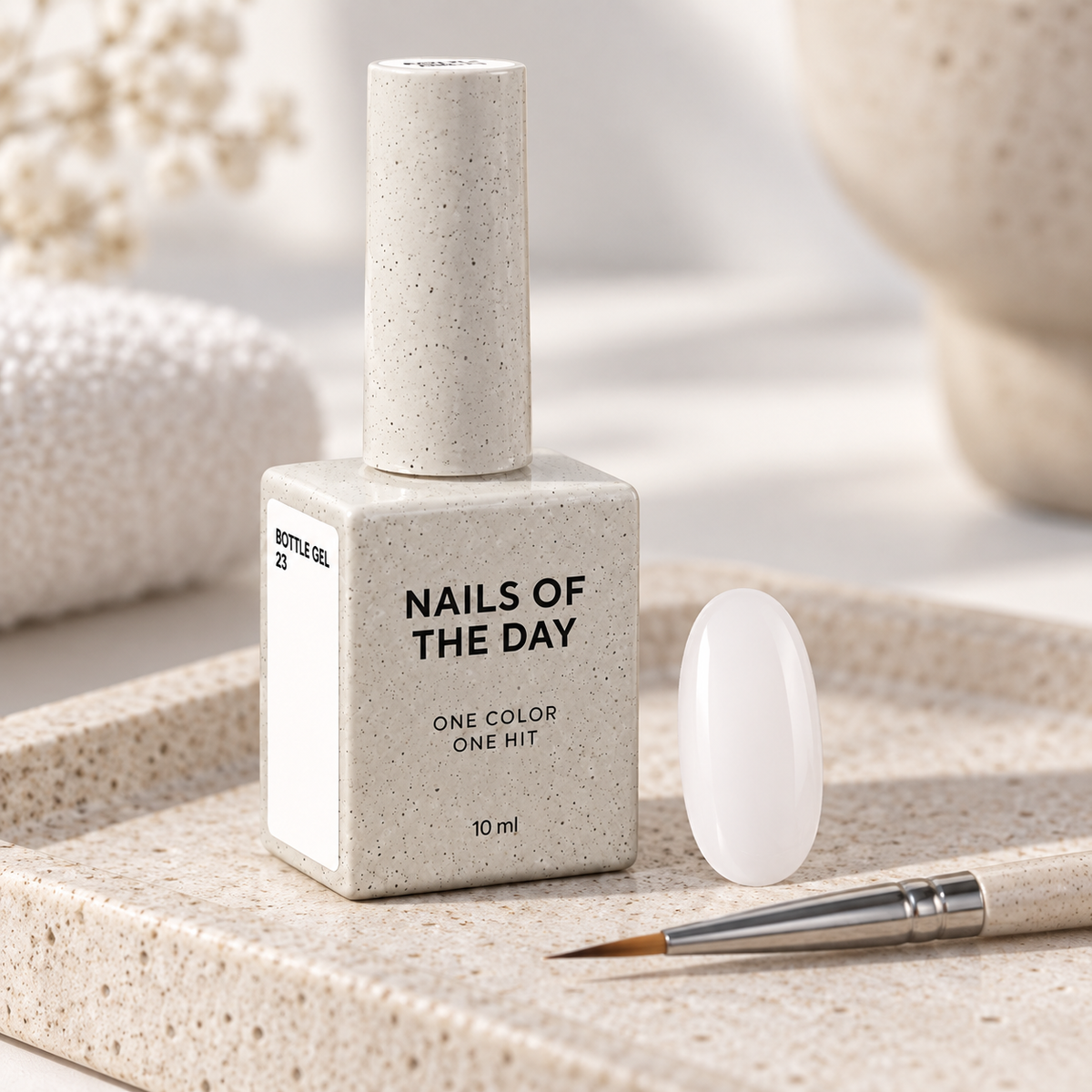 Bottle Gel 23 Nails Of The Day apresentado num ambiente profissional com amostra em tom branco leitoso semitransparente